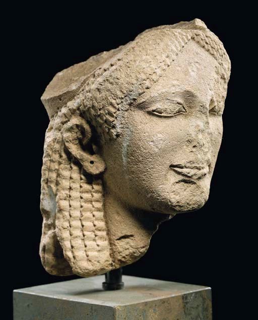 A GREEK LIMESTONE HEAD OF A KORE