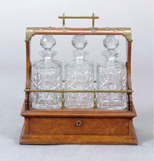 A VICTORIAN BRASS MOUNTED THREE BOTTLE OAK TANTALUS,