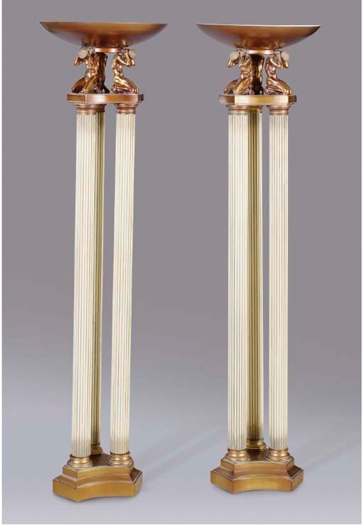 A PAIR OF NEOCLASSICAL STYLE GILT AND PAINT DECORATED METAL TORCHERES,