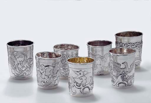 A GROUP OF SEVEN SILVER BEAKERS