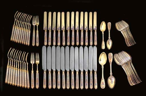 A SILVER-GILT AND CHAMPLEVÉ ENAMEL FLATWARE SERVICE