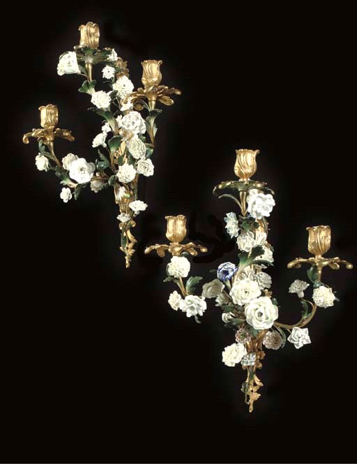A PAIR OF LOUIS XV PORCELAIN-MOUNTED AND POLYCHROME-PAINTED ORMOLU THREE-BRANCH WALL-LIGHTS