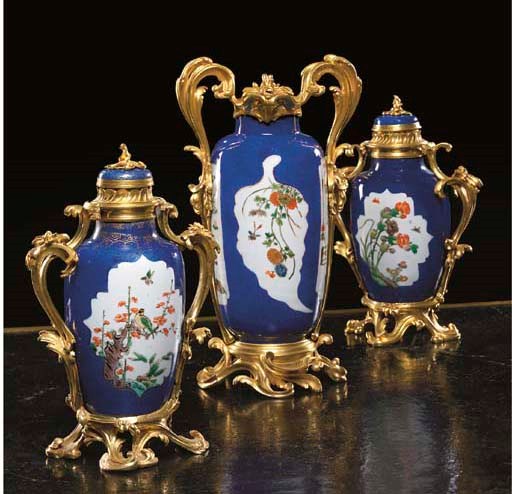 A MATCHED GARNITURE OF THREE LOUIS XV ORMOLU-MOUNTED CHINESE PORCELAIN FAMILLE VERTE AND POWDER BLUE VASES