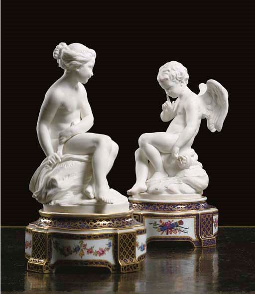 A PAIR OF SEVRES BISCUIT FIGURES OF CUPID AND PSYCHE AND TWO STANDS