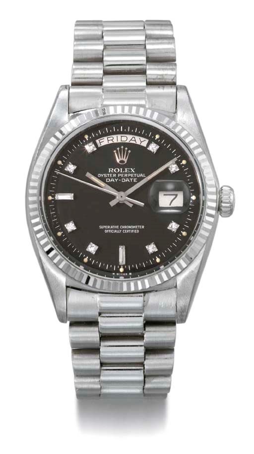 Rolex. An 18K white gold and diamond-set self-winding calendar wristwatch with sweep centre seconds, bracelet and black dial