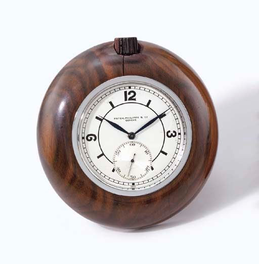 Patek Philippe. A fine and very rare stainless steel and Madagascar ebony desk timepiece with sector dial, usable as desk clock or paper weight