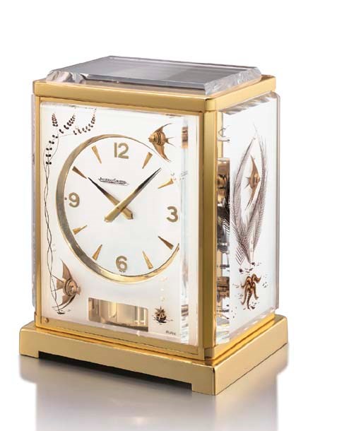 Jaeger-LeCoultre. An unusual gilt and plexiglass Atmos clock with original box