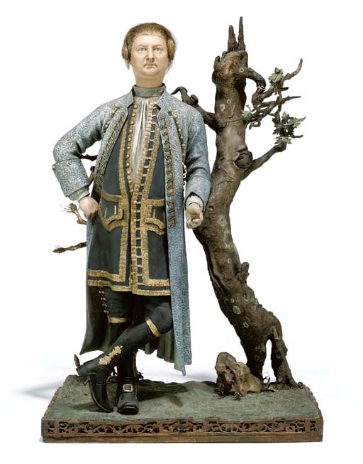 A CHINESE PAINTED CLAY FIGURE TRADITIONALLY IDENTIFIED AS DAVID GARRICK