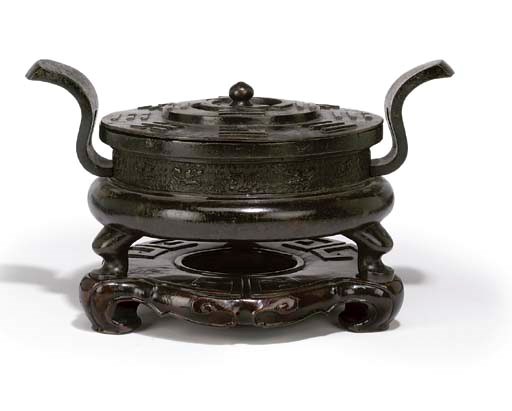 A CHINESE BRONZE CENSER AND COVER