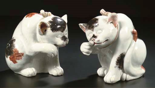 A pair of Arita models of cats