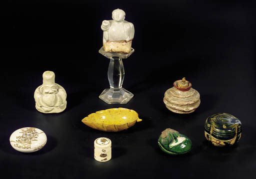 A small Japanese Raku ware box and cover in the form of a sack