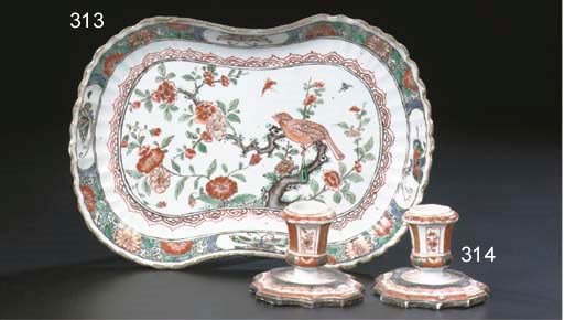 A pair of enamlled small candlesticks