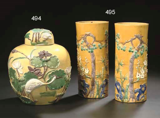 A pair of biscuit cylindrical vases