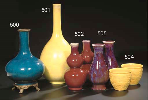 A pair of opaque yellow glass jardinières