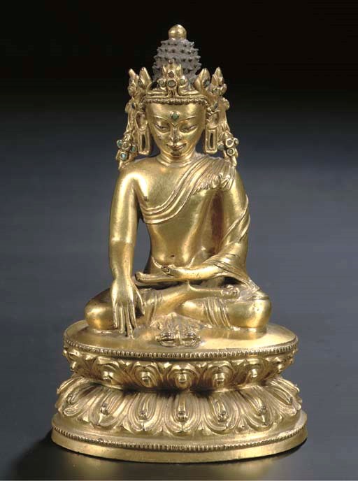A Tibetan gilt-bronze figure of Akshobhya