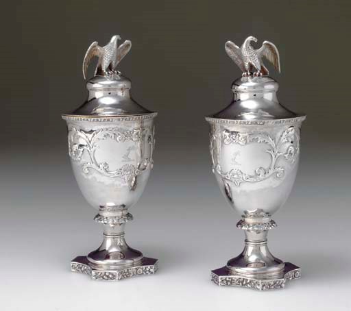 A PAIR OF SILVER COVERED VASES
