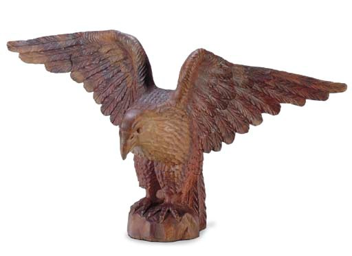 A CARVED AND GILT WALNUT SPREAD-WING EAGLE