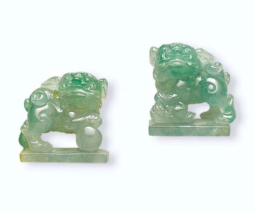 TWO CARVED JADEITE LIONS