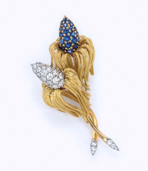 A DIAMOND AND SAPPHIRE FLOWER BROOCH
