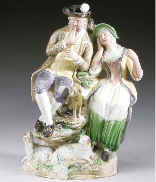 AN ENGLISH PEARLWARE GROUP OF A SHEHERD AND SHEPHERDESS,