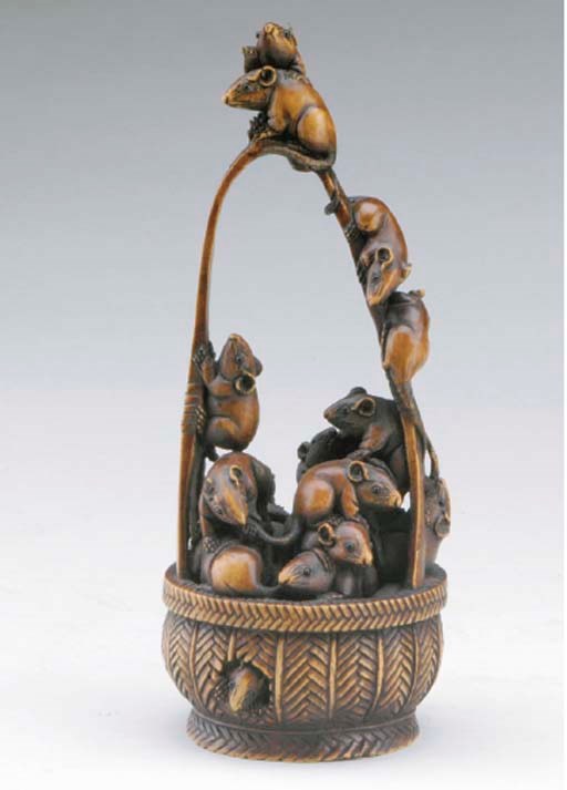A JAPANESE CARVED AND STAINED WOOD OKIMONO OF RATS IN A BASKET**,
