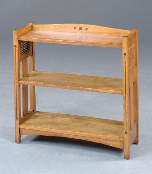 AN ARTS AND CRAFTS OAK AND EBONY-INLAID LOW BOOKCASE,