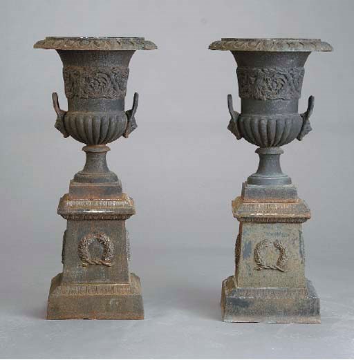 A PAIR OF NEO-CLASSICAL STYLE CAST-IRON GARDEN URNS ON PEDESTALS,