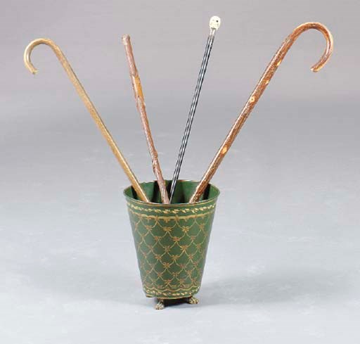 A GROUP OF FOUR CARVED WOOD AND IVORY CANES WITH A TOLE PEINTE BUCKET,**