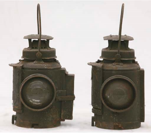 London Midland & Scottish Railway; a pair of large locomotive oil lanterns; black-painted steel with brass fittings; having applied brass plaques with LMS inscriptions, and embossed ventilators inscribed “Adlake Non-Sweating Lam;”; unrestored condition; c.1920s. 	 (2)