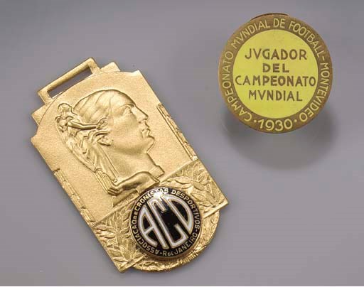 A YELLOW-METAL AND ENAMEL 1930 WORLD CUP LAPEL BADGE