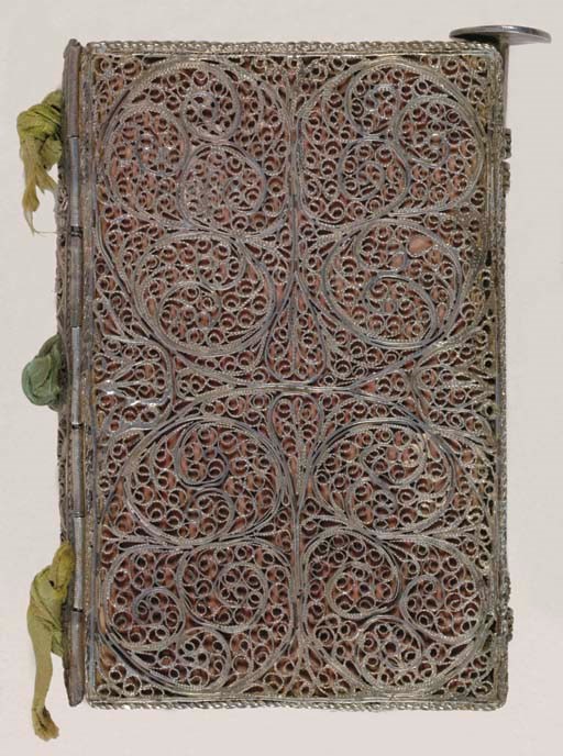 [SILVER BINDING.] A small notebook bound in finely worked silver filigree.  English, late 17th century.