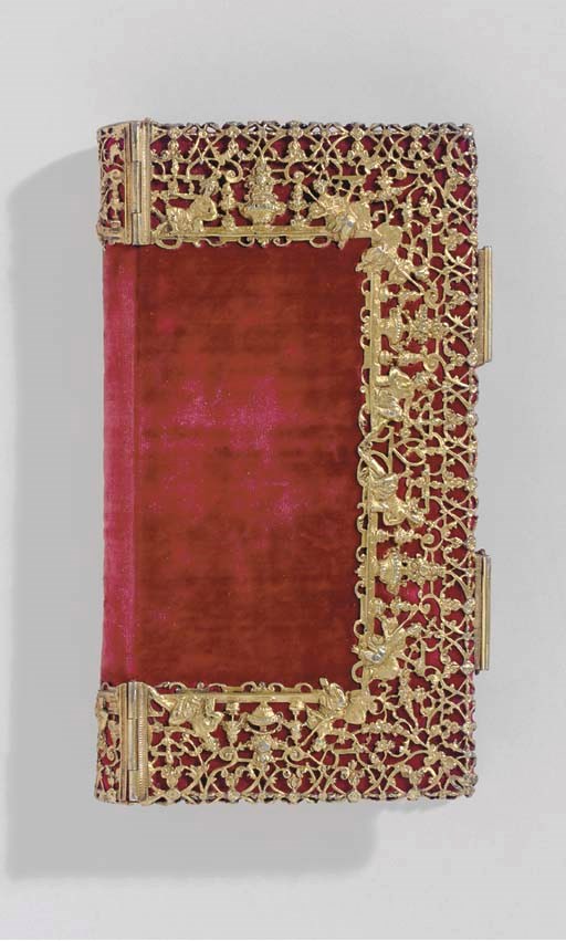 [SILVER BINDING.] A blank book bound in red velvet, a three-quarter silver-gilt filigree border on sides extending around spine, the filigree decorated with Classical figures, floral bouquets, leafy sprays, the clasps decorated en suite. Continental, 19th century. 162 x 94 mm. Provenance: purchased on 6 November 1953.