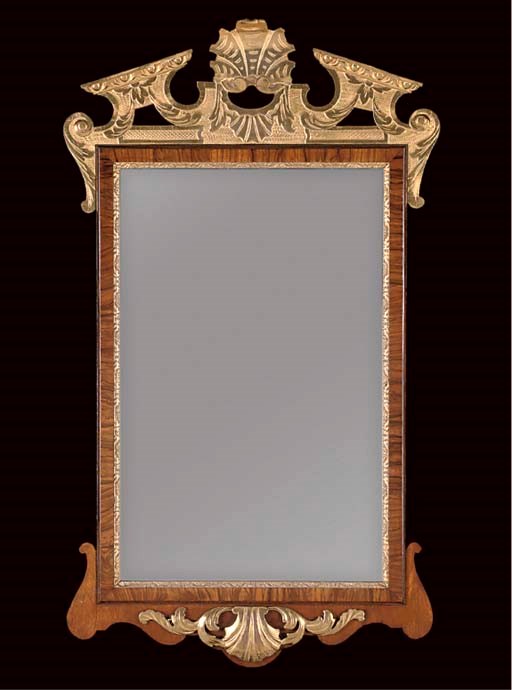 A WALNUT AND PARCEL-GILT MIRROR