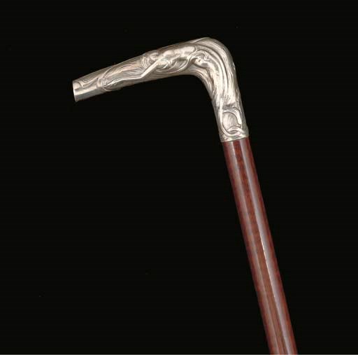 AN ART NOUVEAU WHITE METAL AND SNAKE WOOD WALKING STICK