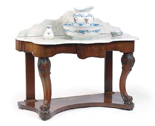 AN EARLY VICTORIAN MAHOGANY SERPENTINE WASHSTAND