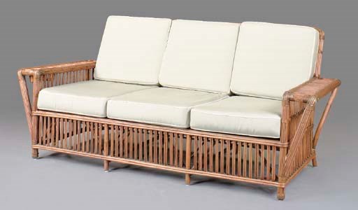 A RATTAN PATIO SETTEE WITH FOAM CUSHIONS,