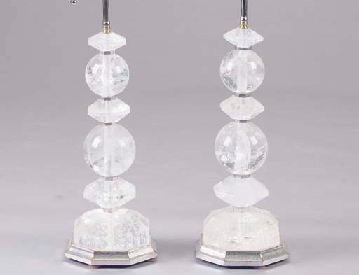 A PAIR OF ROCK CRYSTAL LAMPS ON SILVERED BASES,