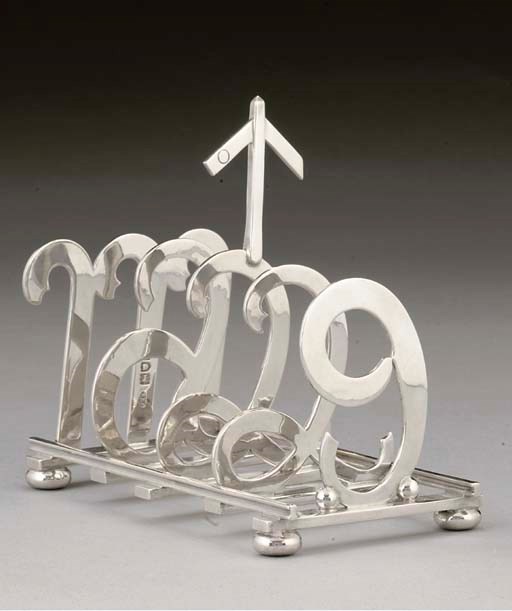 RAILWAY INTEREST:- AN UNUSUAL LATE VICTORIAN NOVELTY SILVER TOASTRACK,
