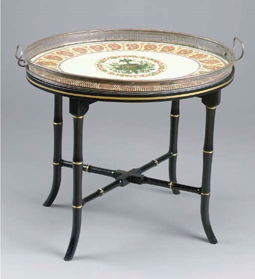 A TOLE PEINTE PEWTER OVAL TRAY ON A LATER EBONISED STAND,