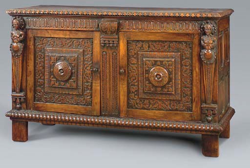 A RENAISSANCE STYLE CARVED WALNUT SIDE CABINET,