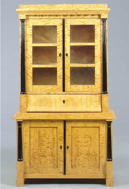 A BIEDERMEIER SATIN BIRCH AND PARCEL-EBONIZED BOOKCASE,