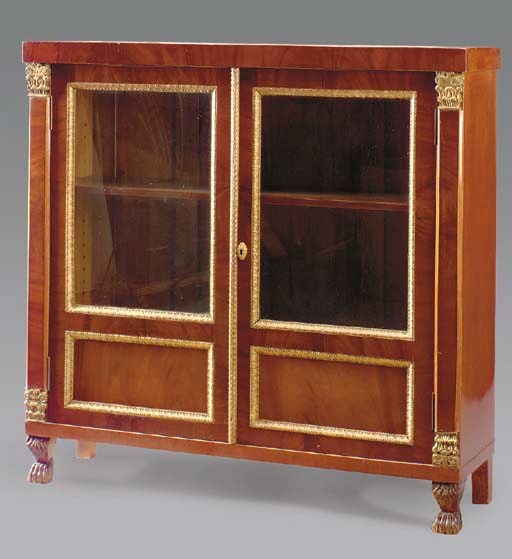A CONTINENTAL MAHOGANY AND PARCEL-GILT DECORATED SIDE CABINET,