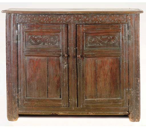 A CHARLES II STYLE CARVED OAK CUPBOARD,