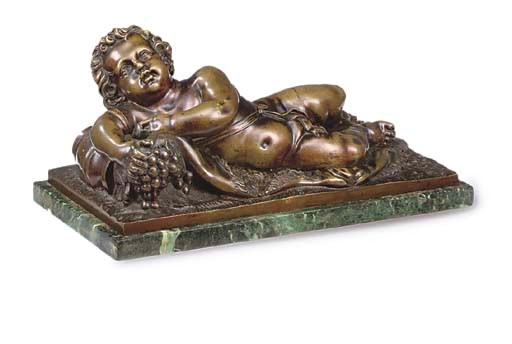 A BRONZE FIGURE OF A RECLINING PUTTO