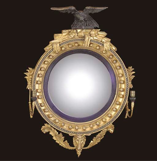 A GEORGE IV GILTWOOD AND EBONISED CONVEX MIRROR