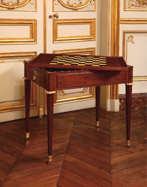 A LOUIS XVI ORMOLU-MOUNTED EBONY AND IVORY-INLAID MAHOGANY TRIC TRAC TABLE**