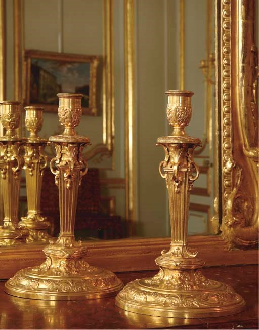 A PAIR OF FRENCH ORMOLU CANDLESTICKS