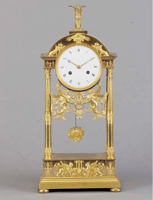 AN EMPIRE GILT-BRONZE PORTICO MANTEL CLOCK,