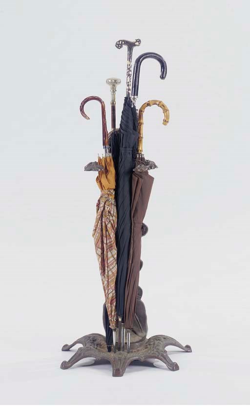 A WROUGHT IRON UMBRELLA STAND TOGETHER WITH A TOLE PAINT STAND AND THIRTEEN UMBRELLAS,