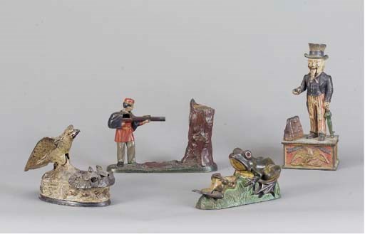 A GROUP OF FOUR PAINTED CAST-IRON MONEY BANKS,